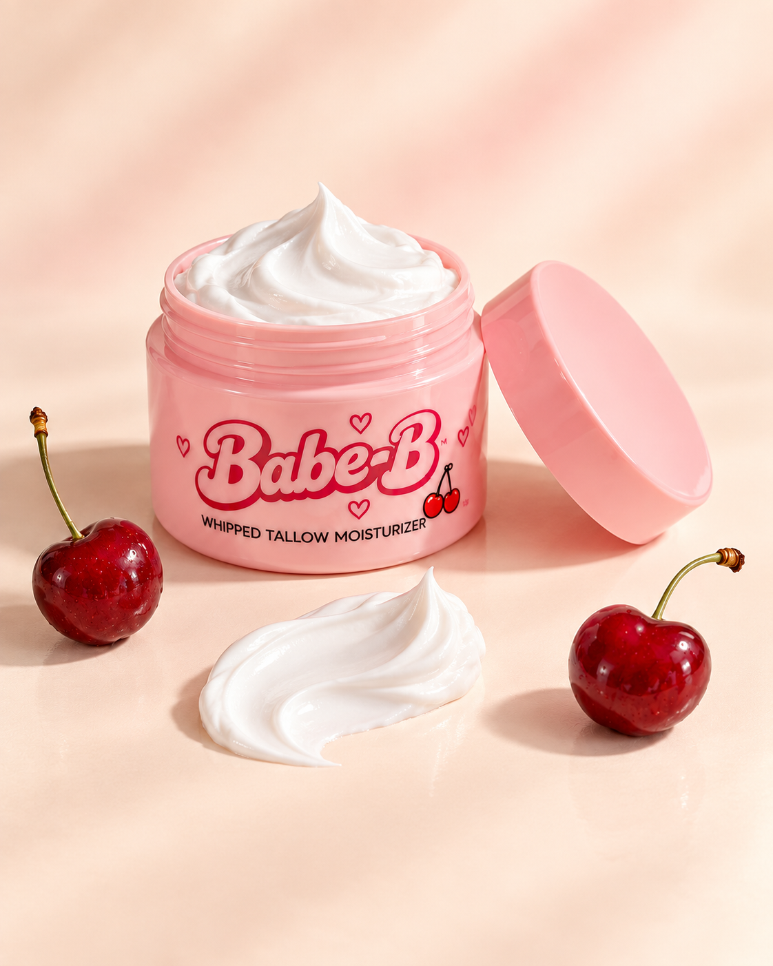 Open pink Babe-B jar with white whipped texture, matching lid and separate cherries